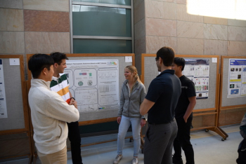 Students gather in front of a poster